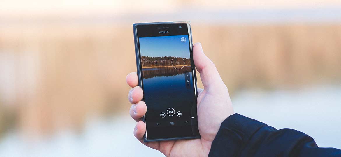 Person Holding Smartphone Person Holding Smartphone